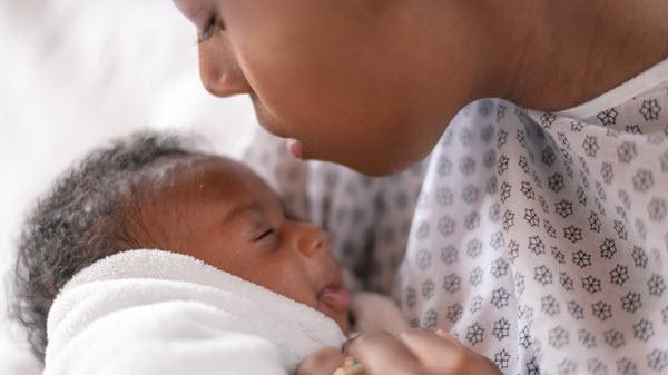 A women holding her newborn child
