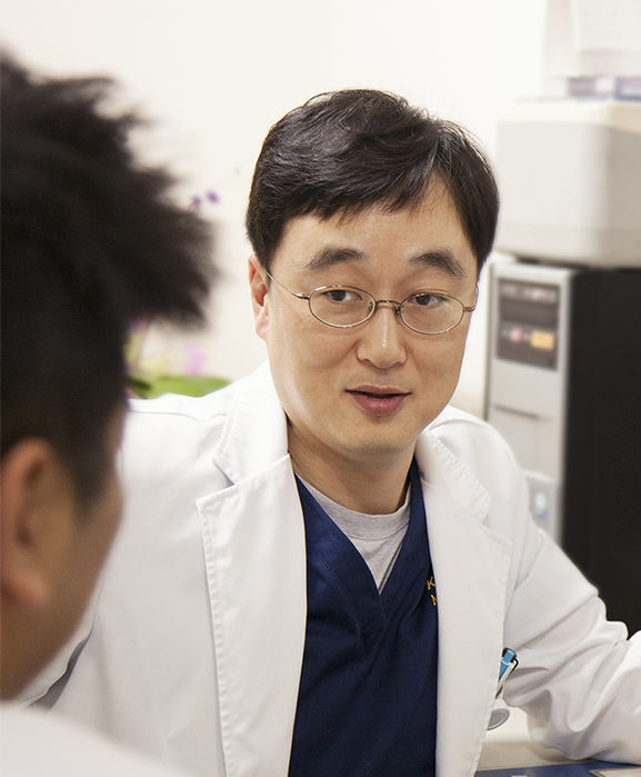 A researcher talks with a colleague about some X-rays