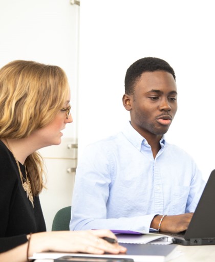 Employees Reviewing Work on a Laptop
