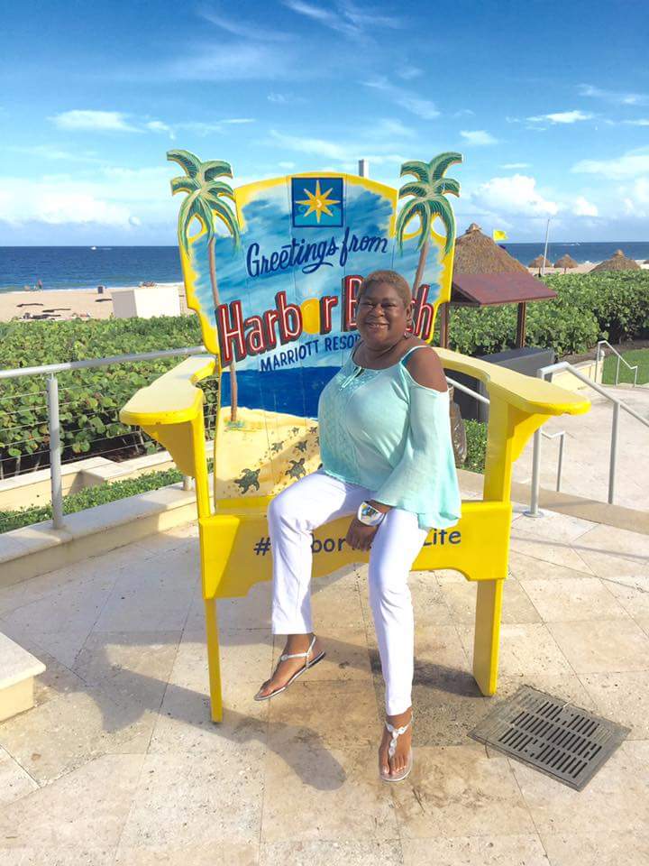 A patient smiles outside a hotel resort