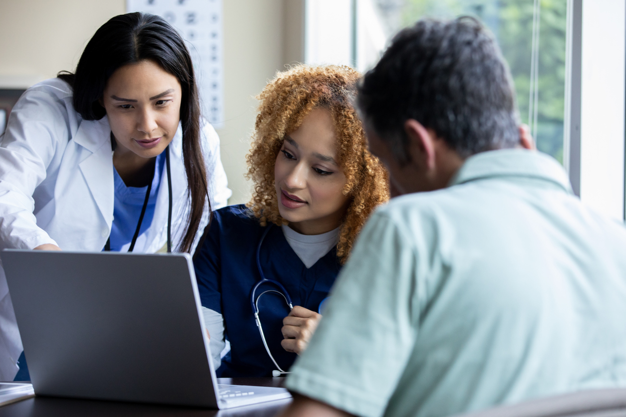 clinicians reviewing results on a laptop