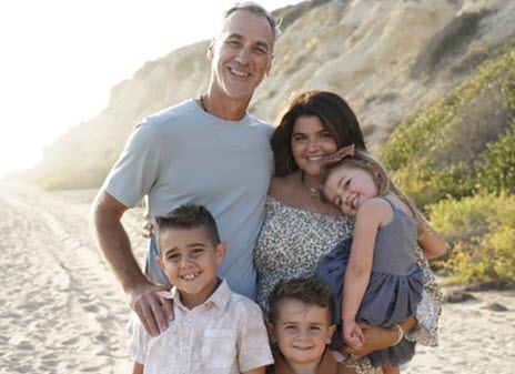 A family takes a picture on the beach
