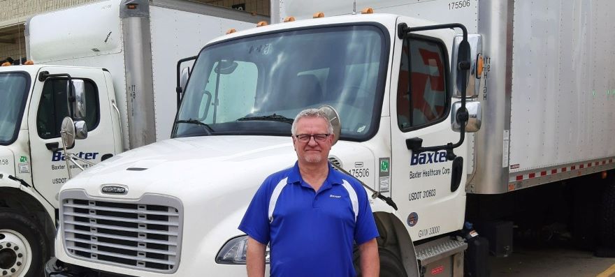 man standing in front of a white truck 