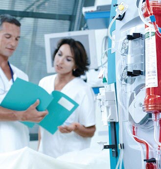 healthcare professionals read a chart in a hospital room