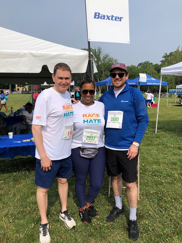 Baxter employees stand outside at a Race Against Hate event