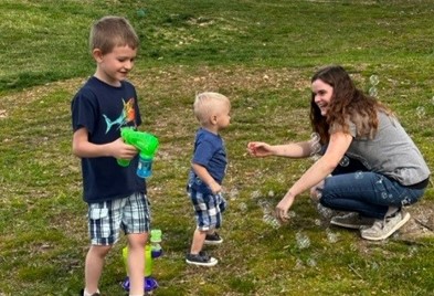 Nicklaus playing bubbles with his mother and brother