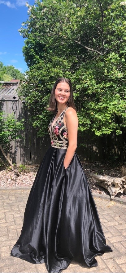 A young women wears a formal dress outside