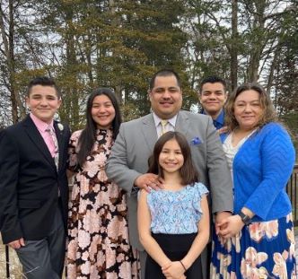 Kim and her family pose together outside