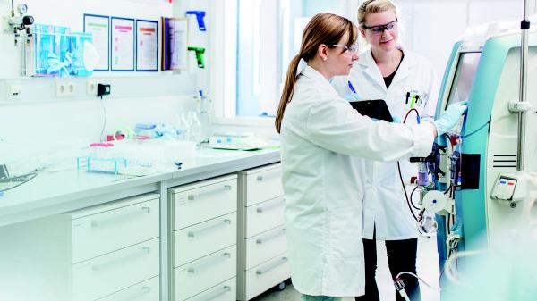 Baxter employees discussing in a lab