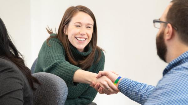 Baxter employees introduce each other with a handshake