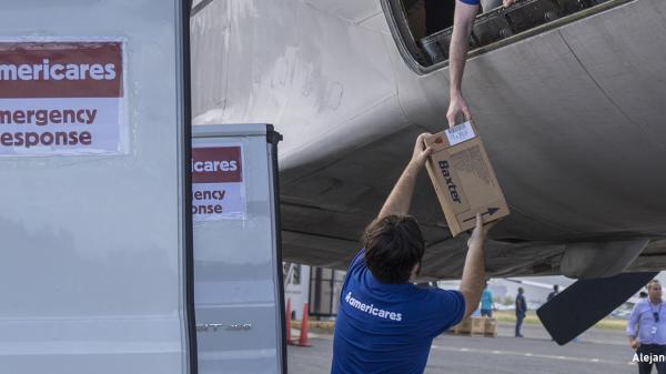 Image of Americares workers unloading boxes of Baxter supplies
