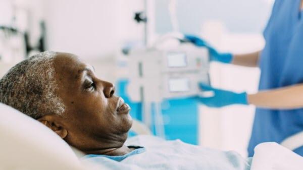 Woman rests on a bed in a hospital