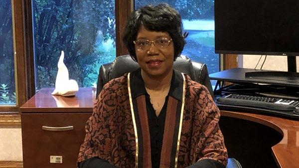 Baxter employee sitting in her home office