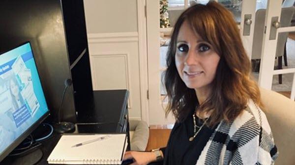 A Baxter employee sits at her home office