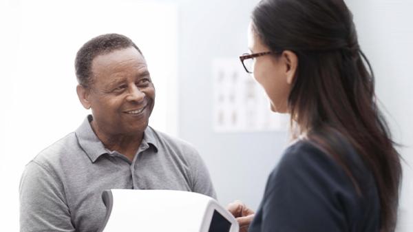 A man and a woman interact in a physician's office