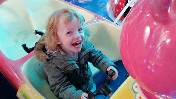 A young girl enjoys an amusement ride