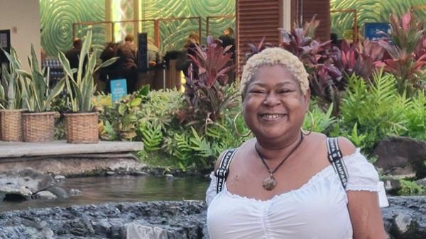 A patient smiles outside a hotel resort