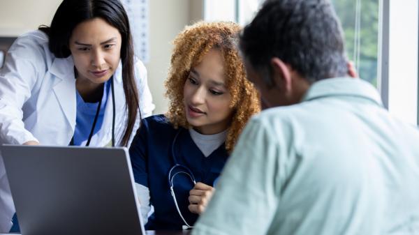 clinicians reviewing results on a laptop