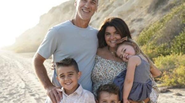 A family takes a picture on the beach