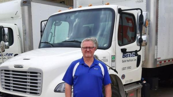 man standing in front of a white truck 