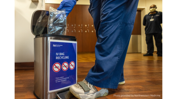 Nurse disposing of IV bag into garbage container. 