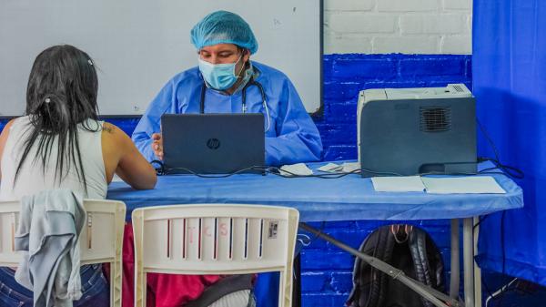 Inside a clinic where a healthcare professional is talking to a patient