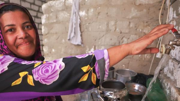 Woman taking tap water