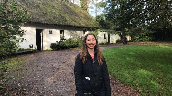 Woman standing outside on some lush green grass