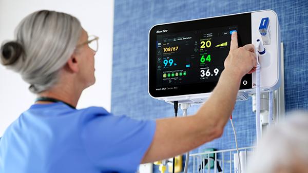 Care team member using a vital signs monitor