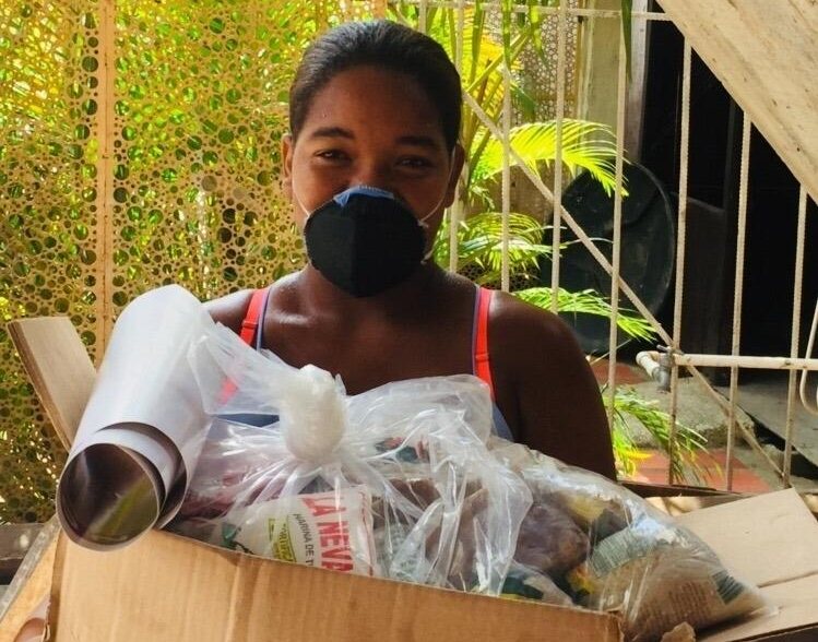 Women holding a care package from Save the Children