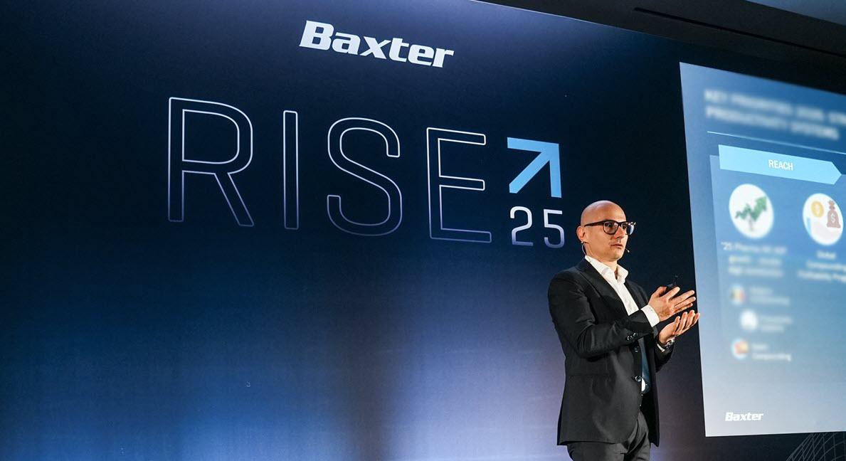 Baxter employee given a presentation in front a blue background