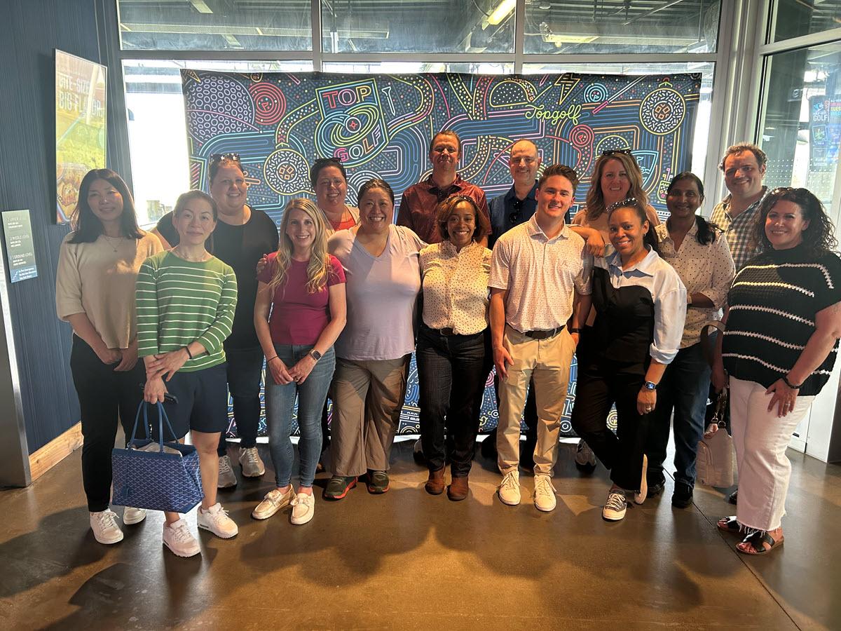 People gather together inside for a team photo