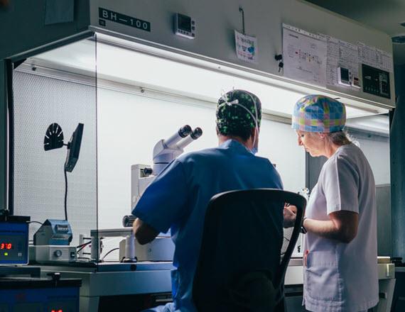 Male and female physicians collaborating in a lab