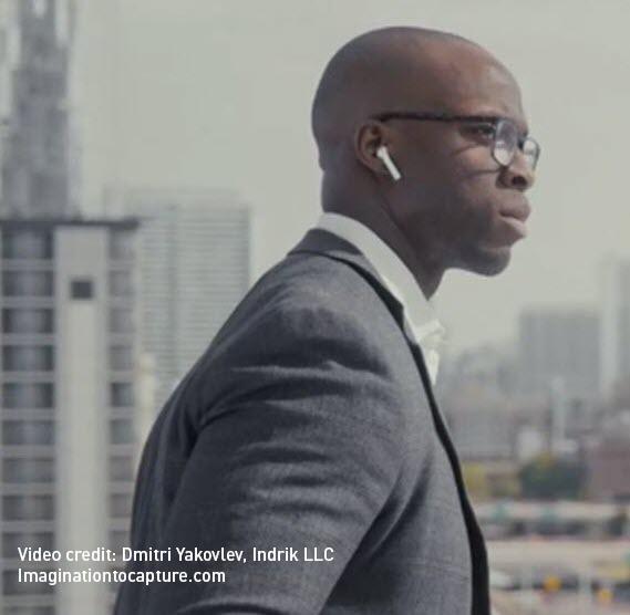 Image of an employee looking out from a balcony