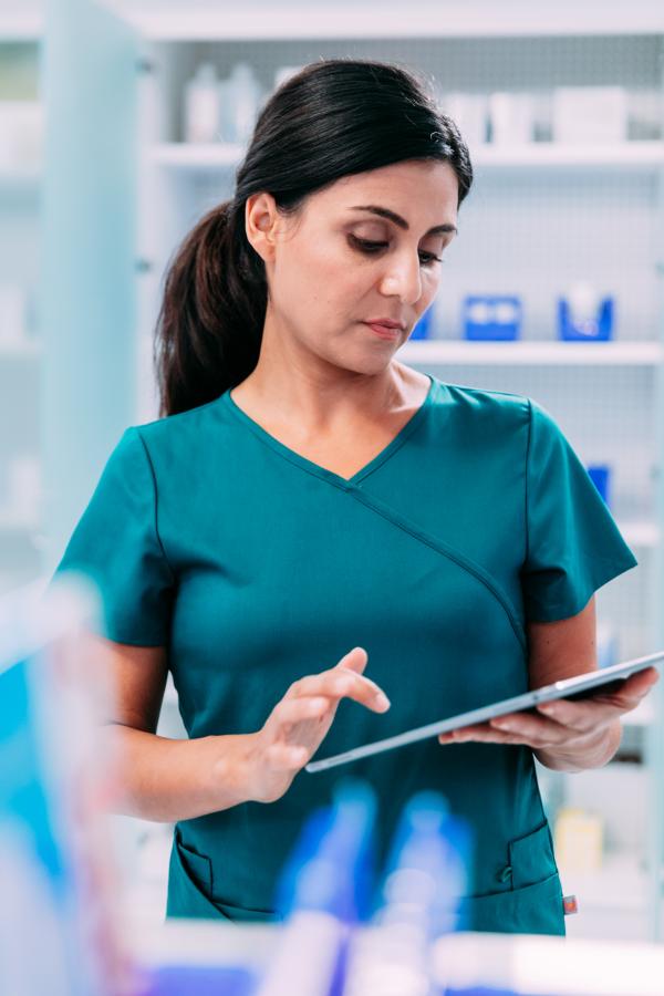 Pharmacist looks up information on a tablet