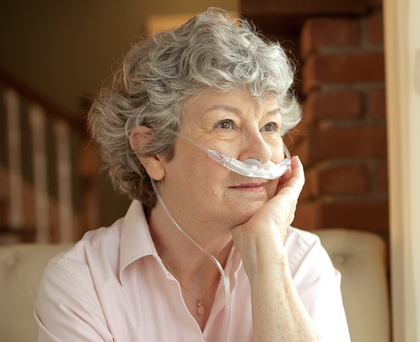 Older patient wearing a medical device to assist breathing