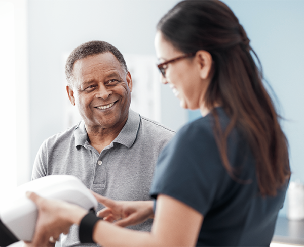 Healthcare professional and patient interacting with medical device