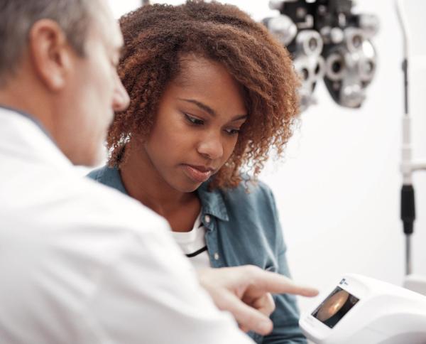 Healthcare professional and patient interacting with medical device