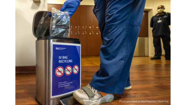 Nurse disposing of IV bag into garbage container.