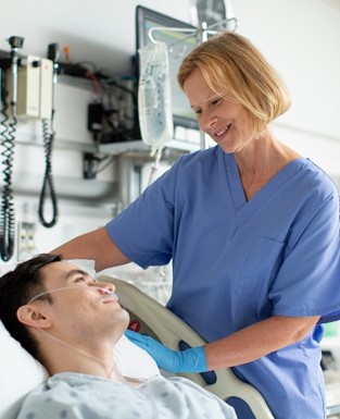 Image of clinician caring for a hospital patient