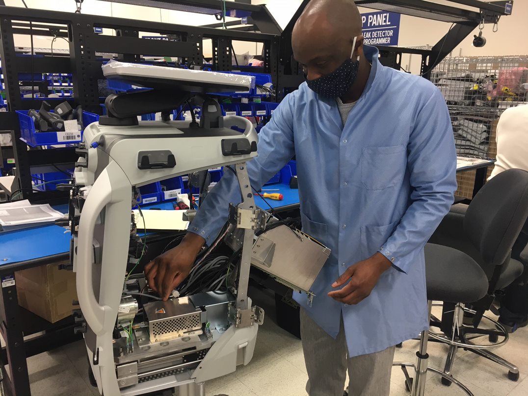 A Baxter employee helps manufacture a blood purification system
