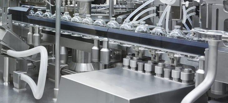 A close up of a manufacturing bottling line