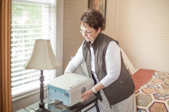AMIA Automated Peritoneal Dialysis System: patient moving her APD machine AMIA Automated Peritoneal Dialysis System: patient moving her APD machine