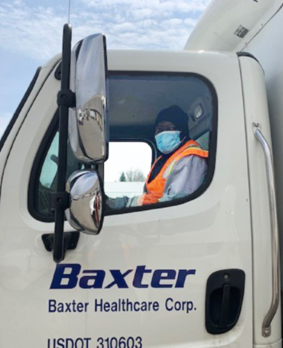 Image of a Baxter driver seated in a delivery truck.