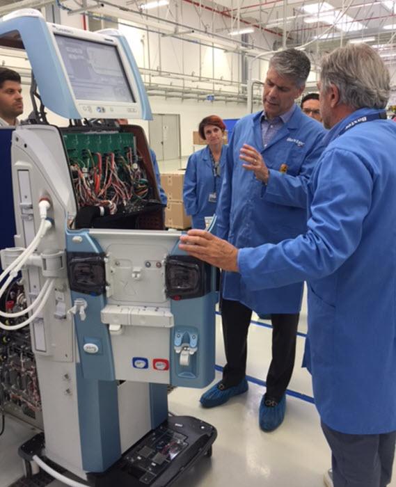 Image of Joe talking with employees at a manufacturing facility in Colombia